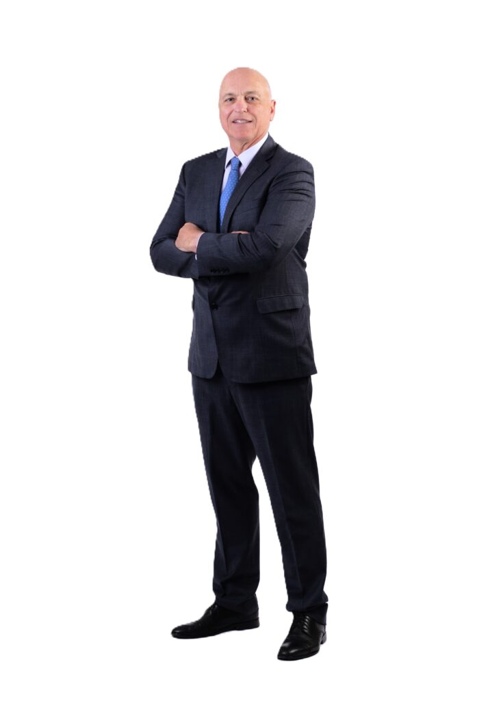 Edward Lear, an experienced litigation attorney, wearing a navy blue checkered suit with a purple tie, standing with arms crossed and a confident smile.